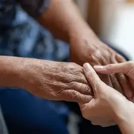 Holding Elderly service user's hand